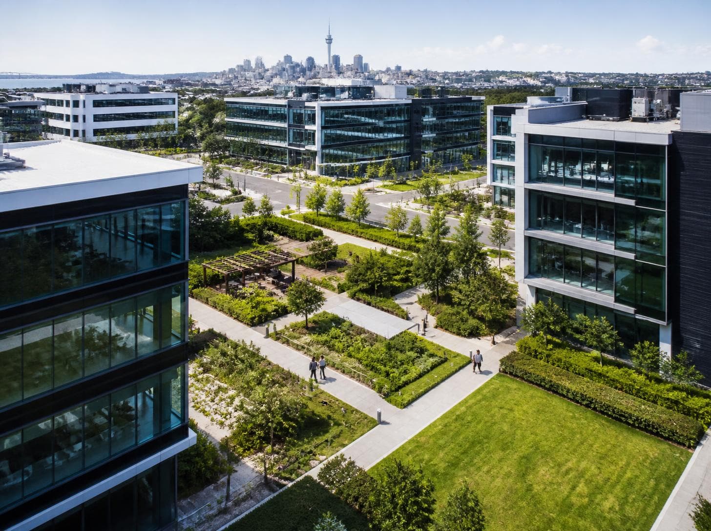 Modern corporate office park exterior with glass facades and landscaped grounds